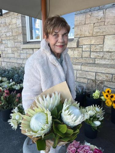 a woman is holding a bouquet of flowers at Cape Pillars Boutique Hotel in Durbanville