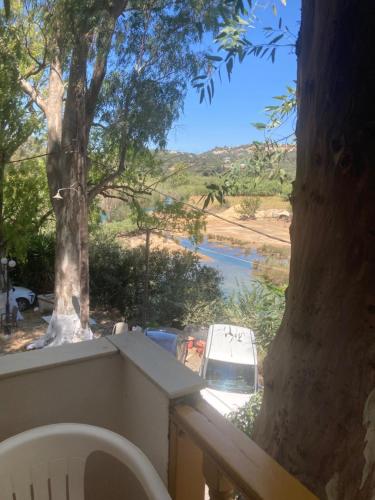 a view of a river from a balcony with a tree at Liberty-Studio N6 in Georgioupolis