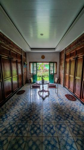 a large room with a table and chairs in it at Rumah Gaharu - Wetan 