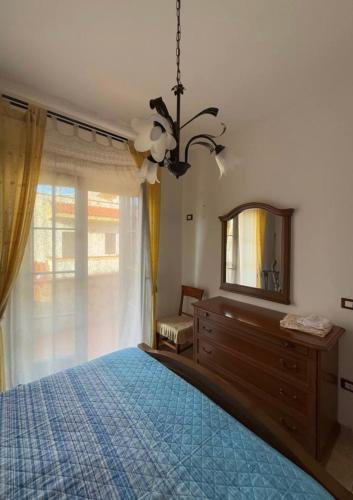 a bedroom with a bed and a mirror and a dresser at La Casa Serena in Scalea