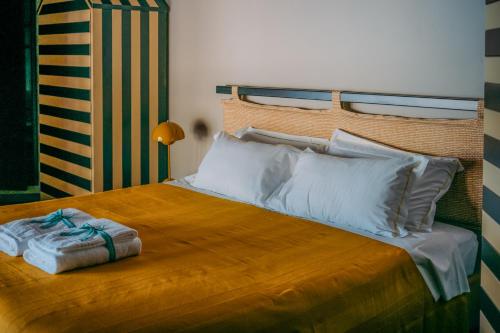 a bedroom with a bed with white pillows at La Casa del Gigante Luxury Collection in Monterosso al Mare
