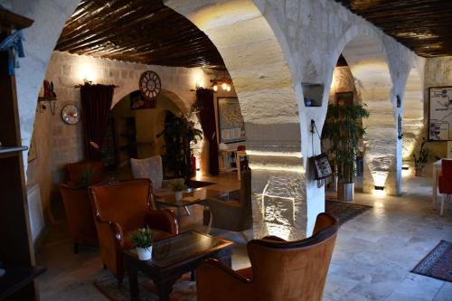 an archway in a restaurant with chairs and tables at Zen Cappadocia House in Goreme