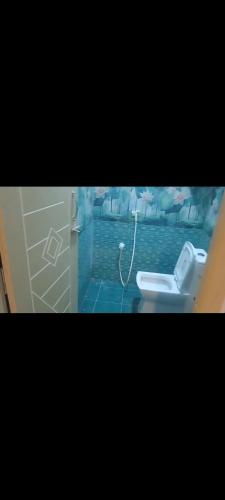 a bathroom with a toilet and a sink at Vhomes in Kuttālam