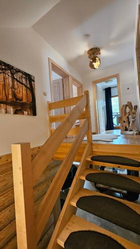 a room with a wooden staircase with chairs in it at Osada Kuboski Dom z Bali Leśny Zakątek in Kamesznica