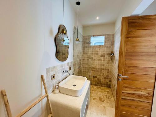 a bathroom with a sink and a toilet in it at Nelayan Reef Apartment in Mantaak