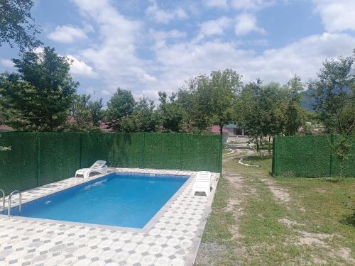 a swimming pool in a yard with a fence at River Garden Gabala -Rooms , Villas in Gabala