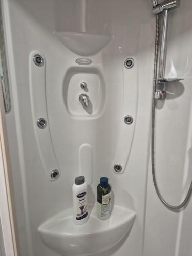 a small bathroom with a sink and a shower at Hana Superior Apartments in Bihać