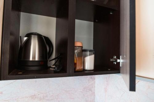 a cupboard with a tea pot and a kettle at Galata Relax in Varna City
