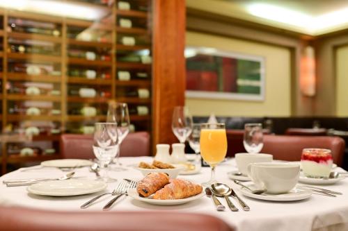 a table with plates of food and glasses of orange juice at Lawlors Hotel Dungarvan in Dungarvan