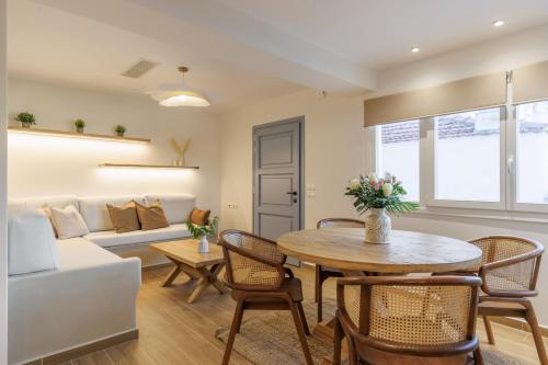 a living room with a table and a couch at Aurora Skopelos in Skopelos Town