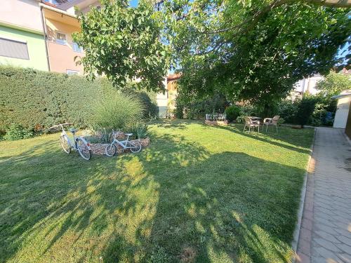 a yard with a bike parked in the grass at A-Niko Apartments in Vinica