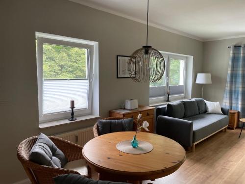 a living room with a table and a couch at Seeperle in Lalendorf