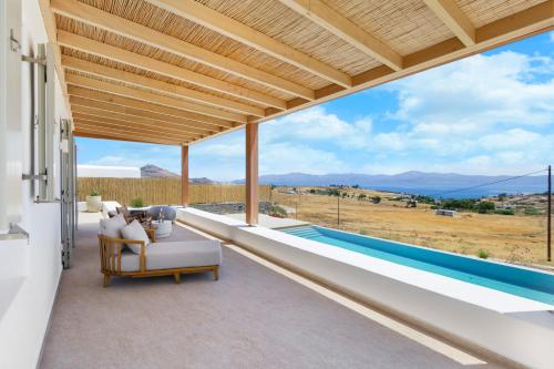 a view from the balcony of a house with a pool at Asana 1 in Márpissa