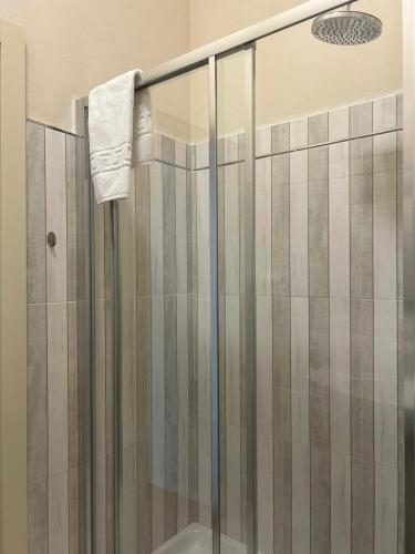 a shower stall with a glass door in a bathroom at Albergo Palazzo Costa in Beverino