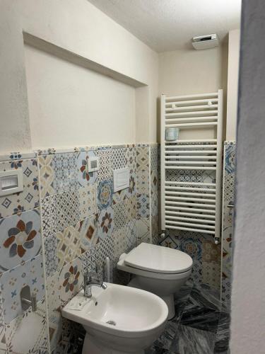 a bathroom with a toilet and a sink at Albergo Palazzo Costa in Beverino