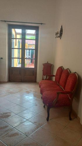 a living room with a chair and a door at Fratti Central Beach Rooms in Viareggio