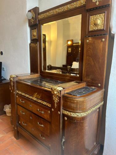 a large wooden dresser with a mirror on it at Albergo Palazzo Costa in Beverino