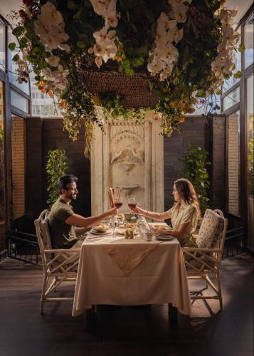 a man and woman sitting at a table with wine glasses at Sonesta Hotel Tower & Casino Cairo in Cairo