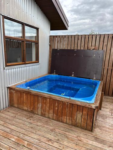 a large blue tub sitting on a deck at Farmhouse on the Golden Circle in Selfoss