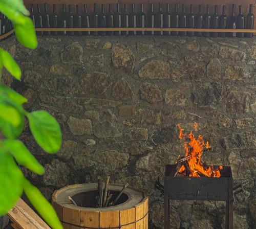 a fire pit in front of a stone wall at White House In Borjomi in Borjomi