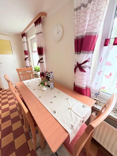 a dining room with a wooden table and chairs at Ferienhaus mit Wasserblick auf der Insel Usedom in Krummin