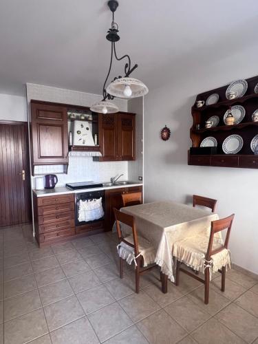 a kitchen with a table and chairs and a counter at La Casa Serena in Scalea