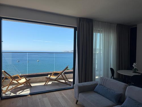 a living room with a large sliding glass door at Lux Apartman Rafailovici in Rafailovici