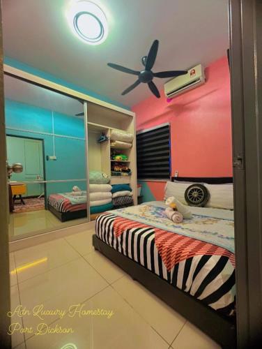 a bedroom with a bed and a ceiling fan at ADN LUXURY Homestay KARAOKE, POOL,NETFLIX,ASTRO,BBQ in Port Dickson