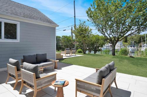 a patio with several chairs and a table and a tablektop at Dockside 2BR - Prime Location on the Marina Unit B in Montauk