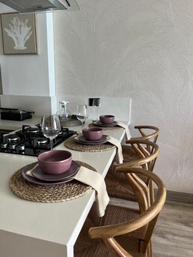a kitchen with a table with two bowls on it at Almare Apartamentos nuevos in Gustavo Rojas Pinilla International