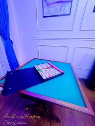 a table with two remote controls on top of it at ADN LUXURY Homestay KARAOKE, POOL,NETFLIX,ASTRO,BBQ in Port Dickson
