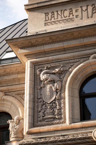 a building with a clock on the side of it at The Marmorosch Bucharest, Autograph Collection in Bucharest
