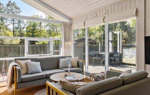 a living room with a couch and a table at 3 Bedroom Stunning Home In Blokhus in Blokhus