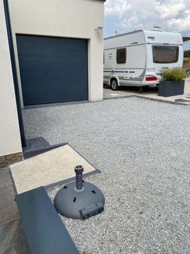 a garage with an rv parked next to a building at La Croisée Chambre d hôte avec sanitaires partagés in Guéreins