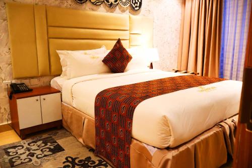 Postel nebo postele na pokoji v ubytování Urban Park Suites Hotel