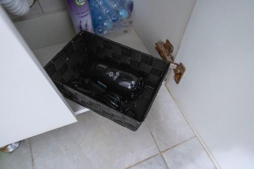 a black basket sitting on the floor in a bathroom at Galata Relax in Varna City