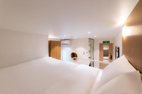 Ένα ή περισσότερα κρεβάτια σε δωμάτιο στο Slowon Hostel 슬로우온 호스텔 홍대