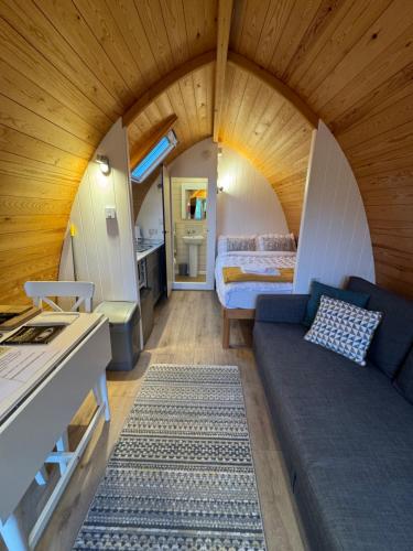 a living room with a couch and a bed at Queensland Holiday Park - Glamping in South West Scotland in Barrhill