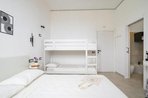 a white room with a bunk bed in it at EnSe Affittacamere in Tortolì