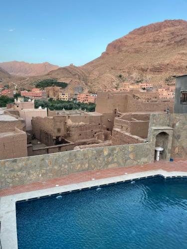 a view of a village with a body of water at Les Jardins De Todgha gorges de todra tinghir in Aït Baha
