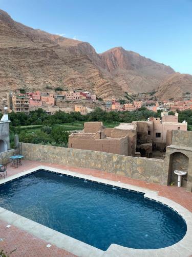 a swimming pool with a view of a city at Les Jardins De Todgha gorges de todra tinghir in Aït Baha