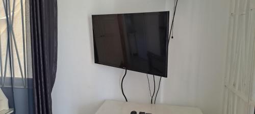 a flat screen tv hanging on a wall at By The Bay Oracabessa Queen Bedroom Suite in Oracabessa