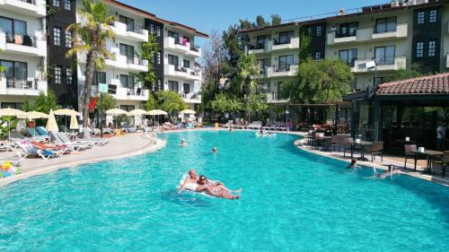 a group of people in a swimming pool at a hotel at LEMAS SUITE HOTEL in Side