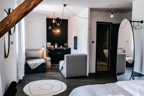 a bedroom with a surfboard and a room with a bed at Penzion Na Červeném Potoce in Králíky