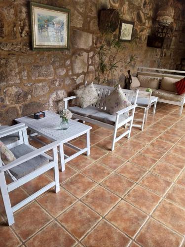 a living room with tables and chairs and a couch at Hotel Gastronómico Casa Rosalia in Brion