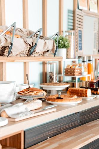 a bakery counter with bread and other food on it at Brit Hotel Confort Saint-Lô in Saint Lo