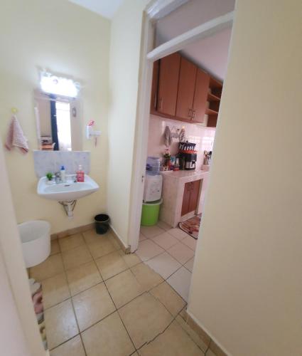 a small kitchen with a sink and a sink at Cozzyville in Machakos