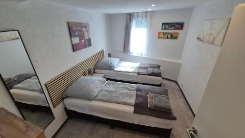a small bedroom with two beds and a window at Volkspark-3-Zimmer-Wohnung-4 Betten-Mainz in Mainz