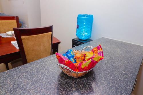 a basket of candy on a table in a room at Modern 3BR Apartment near JKIA and SGR with Free Parking in Athi River