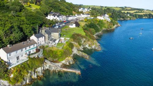 an aerial view of a town on a cliff near the water at Glandore Cliff Cottage Getaway - Sea Access with Private Pier in Glandore